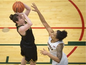 WINDSOR, ONT:. FEBRUARY 16, 2020 -- St. Clair's Logan Kucera, left, takes a shot while being defended by Humber's Jahnae Gyles, in OCAA women's basketball between the St. Clair Saints and the Humber Hawks, at the SportsPlex, Sunday, February 16,  2020.