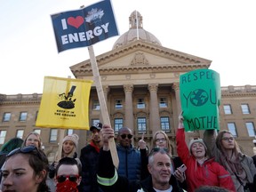 FILE PHOTO: A pro-oil counter-protester stands with climate strikers at the Alberta Legislature in Edmonton, Alberta, Canada October 18, 2019.