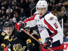 Windsor Spitfires' Egor Afanasyev (11) battles Sarnia Sting's Peter Stratis (42) in front of the Sting's net in the second period at Progressive Auto Sales Arena in Sarnia, Ont., on Friday, Feb. 7, 2020. The Spits beat the Sting 5-4 in OT.