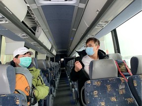 Canadians, who had been evacuated from China due to the outbreak of novel Coronavirus on an American charter plane, board a bus after they disembarked from another aircraft at Canadian Forces Base (CFB) Trenton in Trenton, Ontario, Canada February 7, 2020.