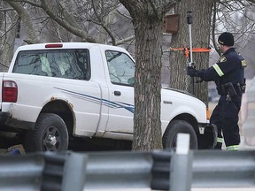 An OPP technical collision investigator examines where a pickup truck crashed into a tree at County Road 50 and Dunn Road in Essex on Feb. 4, 2020.