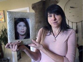 Lara Fournier poses on Thursday, February 20, 2020, with a photo of  her sister Diane Dobson who was murdered 25 years ago in Windsor.