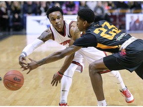 WINDSOR, ON. FEBRUARY 17, 2020 -- Alex Johnson, left, of the Windsor Express makes a pass around  Cornelius Hudson of the Sudbury Five during their game on Monday, February 17, 2020, at the WFCU Centre in Windsor, ON.
