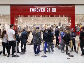 Shoppers wait in line for the grand opening of the Forever 21 Red store at Devonshire Mall Oct. 31, 2015.