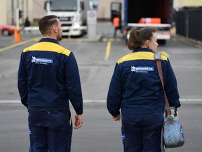 Employees Kristin and Thomas Schmitt walk towards the main gate of the Bamberg branch of French tyre manufacturer Michelin, in Bamberg, Germany, February 13, 2020. Picture taken February 13, 2020.