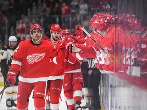 Detroit Red Wings left wing Andreas Athanasiou celebrates his goal with teammates during the third period against the Boston Bruins at Little Caesars Arena.