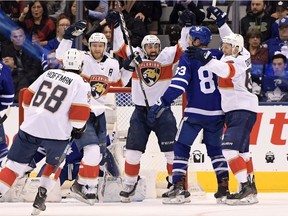 Florida Panthers forward Jonathan Huberdeau (11, second on left) celebrates with team mates after scoring against Toronto Maple Leafs in the third period at Scotiabank Arena.