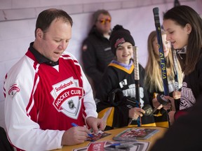 Detroit Red Wing alumni, Kirk Maltby, signs autographs for fans at the Rogers Hometown Hockey outside the Vollmer Culture and Recreation Complex on Feb. 22, 2020.