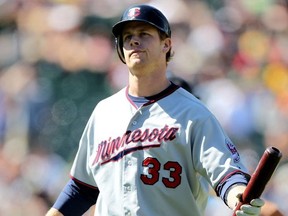 Justin Morneau #33 of the Minnesota Twins reacts after striking out in the ninth inning against the Oakland Athletics during an MLB game at the Oakland-Alameda County Coliseum on June 6, 2010 in Oakland.