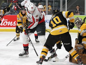 Windsor Spitfires's centre  Curtis Douglas can't find the puck in front of Kingston Frontenacs goaltender Christian Propp and defenceman Nick King during Friday's game.