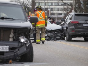 Emergency crews work at the scene of a three-vehicle collision on Ouellette Avenue and Hanna Street, Wednesday, February 12, 2020.  The crash closed northbound traffic on Ouellette Ave., and reduced southbound traffic to one lane.