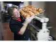 Gwen Lebert, an employee at the Stiemar Bread Co. in Windsor carries a tray of freshly made paczkis on Tuesday, February 25, 2020. Staff were busy selling hundreds of varieties of the tasty treat on Fat Tuesday.