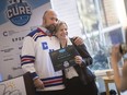 Jeff Casey, event director for Play for a Cure, presents the first award issued by the event - $40,000 to Dr. Caroline Hamm, medical oncologist at Windsor Regional Cancer Program - Wednesday, February 19, 2020.