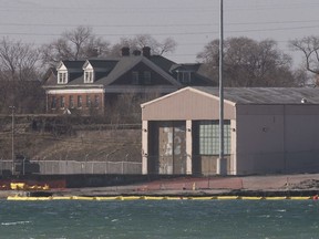 A buoyed tarp is seen along the shoreline where a portion collapsed into the river last month on Feb. 2, 2020.