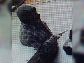 A security camera image of a knife-brandishing robber at the Little Caesars Pizza location at 1091 Lauzon Rd. on the night of Jan. 31, 2020.