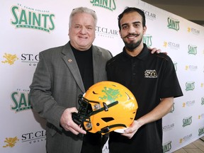 Former AKO Fratmen owner Mike Morencie, left, poses with Kshitij Punj, St. Clair College Saints Student Athletic Association President at a news conference, Feb. 21, 2020, at the SportsPlex. The Saints Student Athletic Association purchased the football club from Morencie.