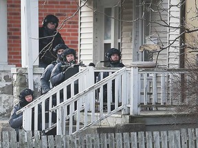 Windsor police officers train their weapons on a residence in the 400 block of Bruce Avenue the morning of Feb. 5, 2020.