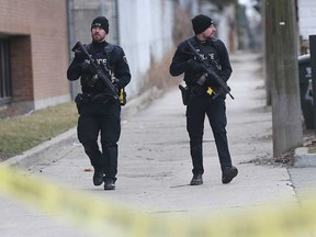 Windsor police officers with C8 carbines keep watch at the scene of a standoff in the 400 block of Bruce Avenue on the morning of Feb. 5, 2020.