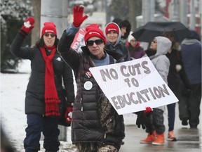 Striking teachers, education workers, support staff and supporters are shown on Thursday, February 13, 2020, in front of Kennedy Collegiate Institute in Windsor.