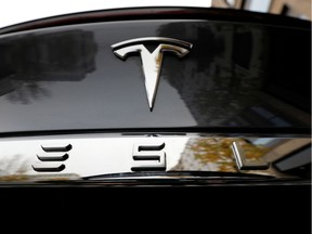 FILE PHOTO: The company logo is pictured on a Tesla Model X electric car in Berlin, Germany, November 13, 2019.