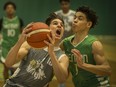 WINDSOR, ONT:. FEBRUARY 23, 2020 -- Riverside's Quinn Carey drives to the basket while Herman's Cortez Kitchen defends during the WECSSAA boys basketball AA final between the Herman Green Griffins and the Riverside Rebels at the SportsPlex, Sunday, Feb. 23, 2020.