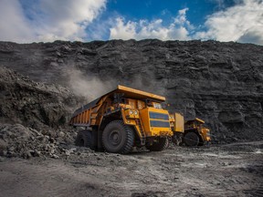 Mining dump trucks loaded in a coal mine.
