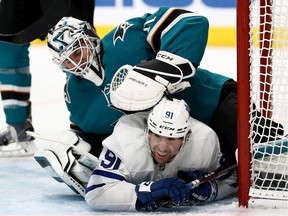 John Tavares of the Toronto Maple Leafs collides with Martin Jones of the San Jose Sharks at SAP Center on March 03, 2020 in San Jose, California.