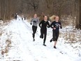 Massey students run in in the Spring Garden Natural Area near the Elgin Street entrance Monday, Feb. 10.