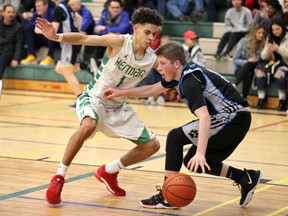 Windsor, Ontario. March 2,, 2020. Herman Green Griffins Cortez Kitchen, left, defends against Sarnia Great Lakes Nolan Caudle in SWOSSAA senior boys AA Final basketball action from the Herman gym Monday.