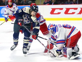 Windsor Spitfires Curtis Douglas looks for rebound against Kitchener Rangers goaltender Jacob Ingham in a March 8, 2020 at the WFCU Centre. It is the last game the Spitfires played before the league was shutdown by the COVID-19 pandemic.
