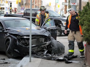 Windsor Fire and Rescue Services personnel assess the scene of a two-vehicle collision at the intersection of Wyandotte Street West and Pelissier Street in downtown Windsor on Monday, March 9, 2020.