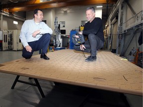 Boris Novakovic, left, and Chris Holtkamp of SPM Automation Canada Inc. stand on a Dura-Base floor Tuesday.  The Dura-Base project was the company's largest project to date.