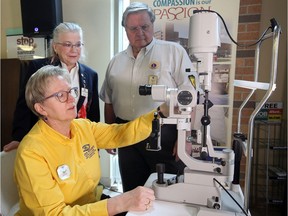 Dr. Gail Tanner, seated, checks out new ophthalmological equipment at Windsor Regional Hospital Ouellette Campus following a generous $100,000 grant from the Downtown Windsor Lions Club and Lions' Regional District to the Windsor Regional Hospital Foundation Wednesday. Behind, Valerie Burningham, left, and Ronald Devos of Downtown Windsor Lions Club watch the demonstration.