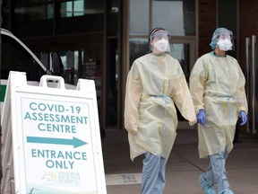 RNs and security staff prepare for patients at the COVID-19 assessment centre at Windsor Regional Hospital's Ouellette Campus on Tuesday.