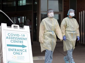 RNs and security staff prepare for patients at the COVID-19 assessment centre at Windsor Regional Hospital's Ouellette Campus on Tuesday.