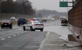 Windsor Police direct traffic away from standing water on E.C. Row Expressway, east of Huron Church Road, after heavy rain in March 2020.  Several vehicles were on the side of the road after driving through about 8 cm of water.