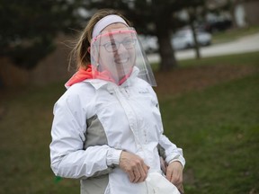 Made-in-Tecumseh protection. Beth Stockford, a nurse at Children's Hospital of Michigan, tries on a protective face shield she received from Dory Azar in Tecumseh on Monday, March 30, 2020. During a time of acute shortages due to the fight against COVID-19, Azar, an architect, is making the personal protective equipment for front-line medical workers using a 3D printer.