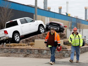 Construction workers leave FCA Chrysler Warren Truck Assembly after the Detroit three automakers have agreed to UAW demands to shut down all North America plants as a precaution against coronavirus. on March 18, 2020 in Detroit, Michigan. - This plant produces the Ram 1500 trucks.