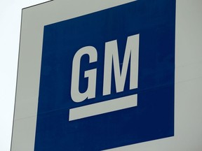 In this file photo taken on January 27, 2020, a sign with the General Motors logo is seen outside the GM Detroit- Hamtramck assembly plant in Detroit.