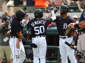 Detroit Tigers right fielder Travis Demeritte is congratulated by designated hitter Miguel Cabrera and center fielder Victor Reyes after his two run home run during the first inning against the New York Yankees at Publix Field at Joker Marchant Stadium.