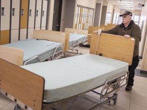 David Purdie, from St. Clair College, loads up hospital beds from the Anthony P. Toldo Centre for Applied Health Sciences, to be delivered to Hotel Dieu-Grace Healthcare, Tuesday, March 24, 2020, as the COVID-19 pandemic continues.