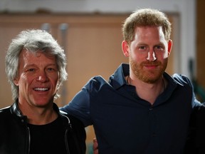 Britain's Prince Harry and musician Jon Bon Jovi pose for a picture with choir members during a visit at Abbey Road Studios in London, Britain, on Feb. 28, 2020.