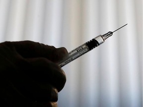 FILE PHOTO: A doctor prepares a syringe as part of the start of the seasonal influenza vaccination campaign in Nice, France October 24, 2018.