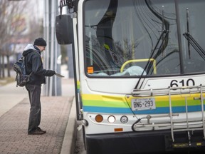 Phil Parent, who lives in LaSalle and uses Transit Windsor to get to work most days, gets on the South Windsor 7 in front of Malden Village, Friday, March 27, 2020.