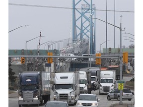 Transport trucks, like those shown dominating the traffic flow on Huron Church Road on Thursday, March 19, 2020, will be among the "essential" travellers still permitted to cross the international border by Saturday. Tourists and visitors from Canada and the US will be barred from entering the other country.