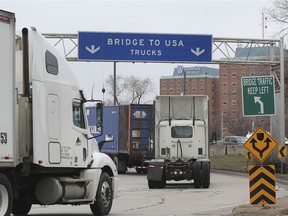 Truck drivers make their way to the Ambassador Bridge from Windsor, ON. on Thursday, March 19, 2020.