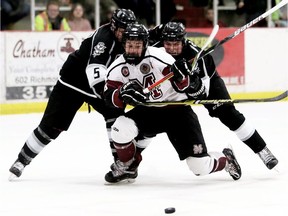 Chatham Maroons' Evan Wells (88) is knocked down by LaSalle Vipers' Derek Berdusco (5) and Matt Carvalho (8) in the third period of Sunday's game in Chatham.