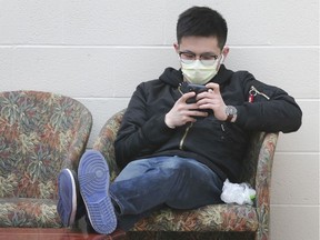 A man wears a surgical mask while waiting for a train at the Via Rail Station in Windsor on Thursday, March 12, 2020.