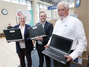 Jennifer Soulliere and  and Liam Giles-Hayes, centre, from United Way Windsor-Essex County are shown with Philip Schaus, President and CEO of Corporations for Community Connection on Thursday, March 12, 2020 at the Via Rail Station in Windsor. The organization is delivering hundreds of laptops and SMART boards from Windsor to Quebec City. They delivered laptops to various groups in Windsor chosen by the local United Way.