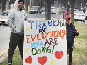 Nurses and support staff getting off from work on the afternoon of March 27, 2020 at Windsor Regional Hospital's Met campus were greeted by residents thanking them for their work during the COVID-19 pandemic. Here, Chris Menard and his son Rocco cheer on hospital staff.